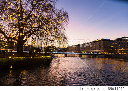 Geneve. Switzerland - December 30, 2021: Sunset over Geneva. Embankment of leman River 89051611