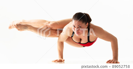 Sporty beautiful young woman practicing yoga, doing lunge exercise, Revolved Side Angle Pose, , working out wearing red and black sportswear, studio full length, isolated white background. Sporty beautiful young woman practicing yoga, doing lunge exercise, Revolved Side Angle Pose, , working out wearing red and black sportswear, studio full length, isolated white background. 89052758