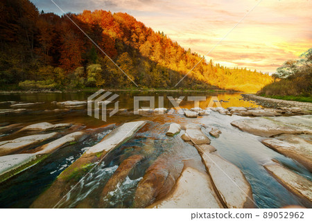 View of the waterfall in autumn. Waterfall in autumn colors. Mountain river in the autumn landscape. Ukraine, river Stryj. 89052962