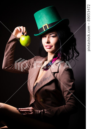 Halloween. A terrible wicked witch holds a poisoned apple in her hands, standing in her lair among the cobwebs. Evil black magic. Halloween. A terrible wicked witch holds a poisoned apple in her hands, standing in her lair among the cobwebs. Evil black magic. 89053472