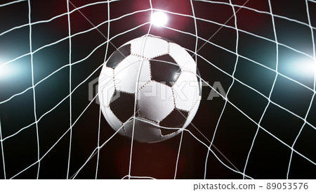 Soccer ball in goal, isolated on black background Soccer ball in goal, isolated on black background 89053576
