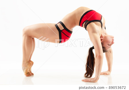 Sporty beautiful young woman practicing yoga, doing lunge exercise, Revolved Side Angle Pose, , working out wearing red and black sportswear, studio full length, isolated white background. Sporty beautiful young woman practicing yoga, doing lunge exercise, Revolved Side Angle Pose, , working out wearing red and black sportswear, studio full length, isolated white background. 89053672