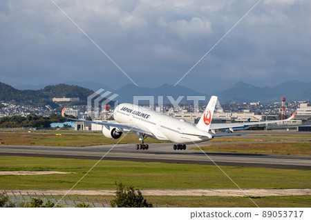 Passenger plane taking off from Osaka Airport, Japan Airlines, A350 89053717