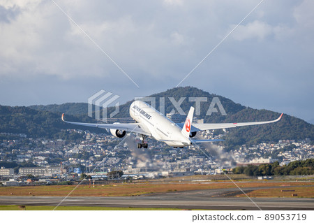 Passenger plane taking off from Osaka Airport, Japan Airlines, A350 89053719