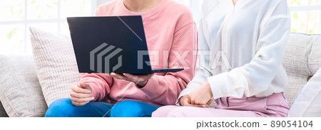 Image cut of a couple staring at the screen of a laptop computer Image cut of a couple staring at the screen of a laptop computer 89054104