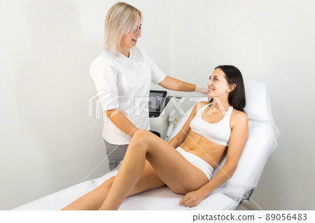 Dermatologist doctor and female patient in cosmetology office. Consultation before laser hair removal 89056483