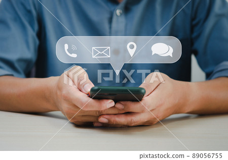 Businessman hand holding a smart phone using contact information and talking. Business communication concept. 89056755