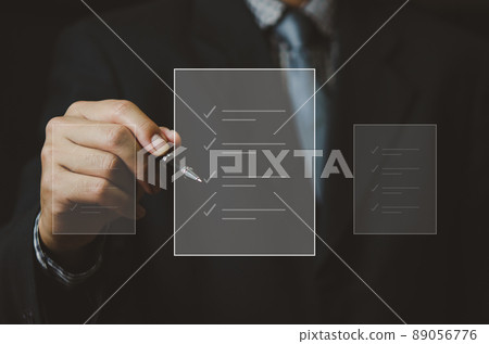 businessman holding pen to check business digital documents on virtual screen. businessman holding pen to check business digital documents on virtual screen. 89056776