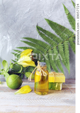 Natural soap, lime, yellow lily flower, aromatic oil on a wooden table, on the background of a fern leaf, spa, organic cosmetics for body care and relaxation Natural soap, lime, yellow lily flower, aromatic oil on a wooden table, on the background of a fern leaf, spa, organic cosmetics for body care and relaxation 89057724