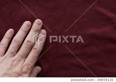 man hand touching red wine color cotton fabric man hand touching red wine color cotton fabric 89059116