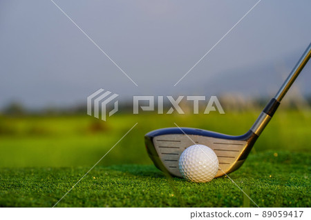 Golf club and ball on green grass ready to be struck on golf course background Golf club and ball on green grass ready to be struck on golf course background 89059417