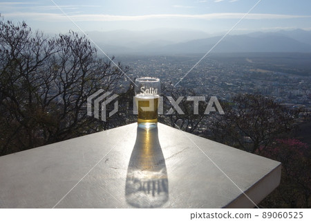 beer cup reflecting Salta city name, Argentina, cityscape buildings 89060525