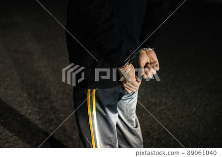 The arm of a man who is handcuffed in the back The arm of a man who is handcuffed in the back 89061040