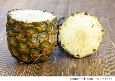 cut into pieces ripe yellow pineapple on the table 89061656