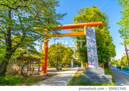 Kawasaki cityscape of Japan Inage Shrine in Kawasaki surrounded by fresh greenery. (A blue bicycle priority lane was set up on the right sidewalk) 89062340