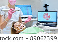Woman having her teeth 3d scanned by professional dentist. 89062399
