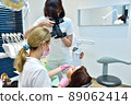 Woman dentist taking pictures of teeth before teeth whitening procedure. 89062414