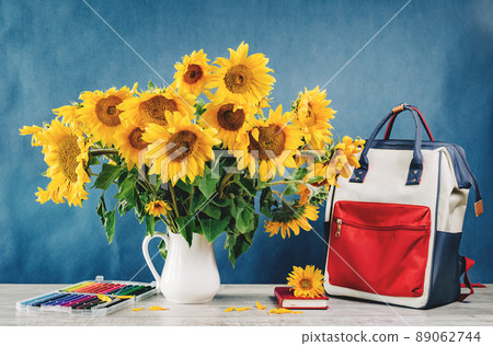 Sunflowers bouquet in a floral arrangementon a table 89062744