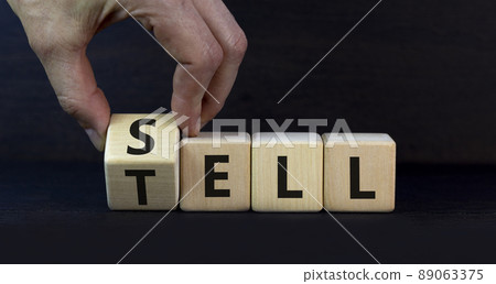 Sell or tell symbol. Businessman turns a wooden cube and changes the concept word Tell to Sell. Beautiful grey table grey background, copy space. Business and storytelling storyselling sell or tell Sell or tell symbol. Businessman turns a wooden cube and changes the concept word Tell to Sell. Beautiful grey table grey background, copy space. Business and storytelling storyselling sell or tell 89063375