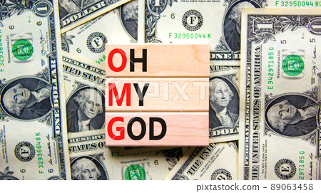 OMG oh my god symbol. Concept words OMG oh my god on wooden blocks on a beautiful background from dollar bills. Business and OMG oh my god concept. Copy space. OMG oh my god symbol. Concept words OMG oh my god on wooden blocks on a beautiful background from dollar bills. Business and OMG oh my god concept. Copy space. 89063458