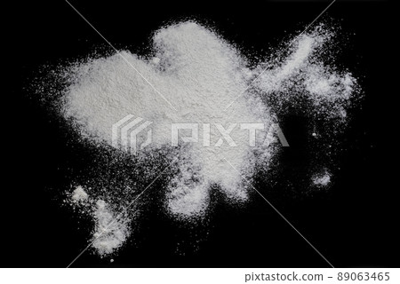 Black background sprinkled with flour, smeared flour, table for cooking, rolling dough. Preparing for baking, top view on a black background or table. Preparation of dough or dough. 89063465