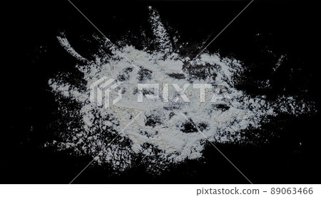 Black background sprinkled with flour, smeared flour, table for cooking, rolling dough. Preparing for baking, top view on a black background or table. Preparation of dough or dough. 89063466