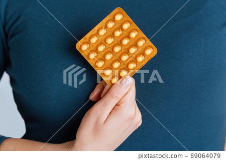 Vitamins And Dietary Supplements. Woman Holding  Vitamin Pill In Hand. Closeup Of Happy Girl Taking Medication. Healthy Diet Nutrition Concept. Image tablet of activated charcoal in female hands. 89064079