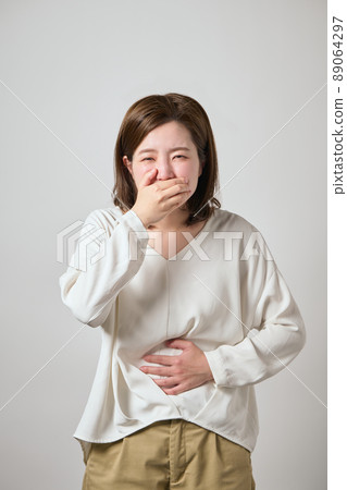 Young woman with food poisoning, nausea and abdominal pain Young woman with food poisoning, nausea and abdominal pain 89064297