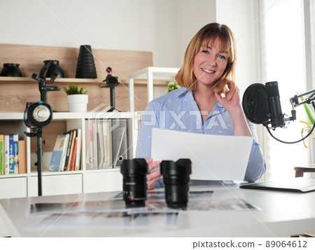 Female photographer working at office studio Female photographer working at office studio 89064612