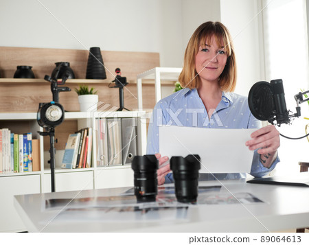 Female photographer working at office studio 89064613