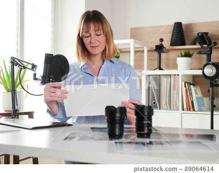 Female photographer working at office studio Female photographer working at office studio 89064614