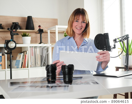 Female photographer working at office studio 89064615