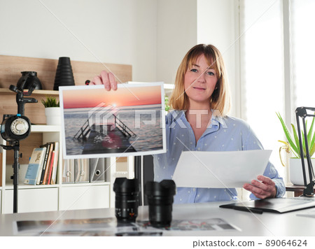 Female photographer working at office studio 89064624
