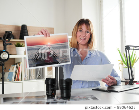 Female photographer working at office studio 89064625
