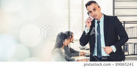 Business people wearing headset working in office broaden view 89065241