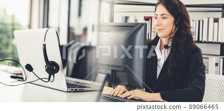 Business people wearing headset working in office broaden view Business people wearing headset working in office broaden view 89066465