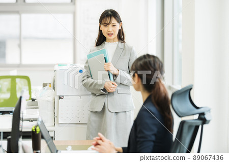 Woman having a conversation in the office Woman having a conversation in the office 89067436