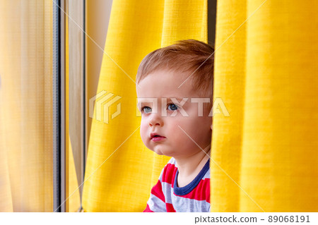 Little boy looking out the window. Close-up. Little boy looking out the window. Close-up. 89068191