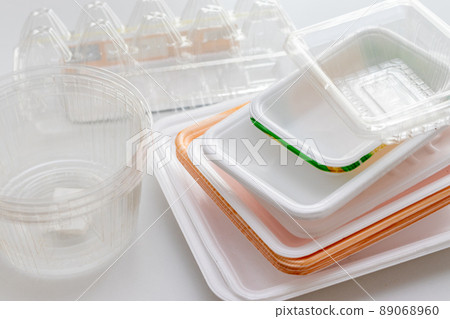 Plastic trash on a white table Plastic trash on a white table 89068960