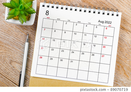 August 2022 desk calendar with pen on wooden table. August 2022 desk calendar with pen on wooden table. 89070719