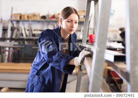Portrait of woman looking at profile steel profile tube Portrait of woman looking at profile steel profile tube 89072491