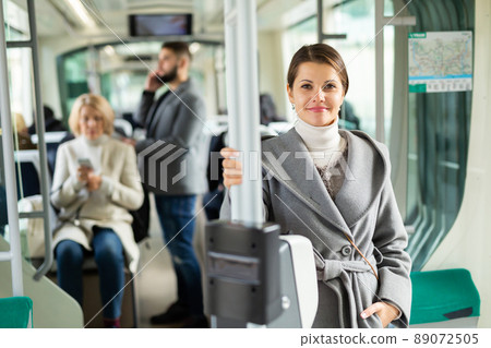 Smiling brunette in public transport 89072505
