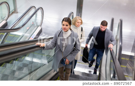 People moving up on escalator 89072567