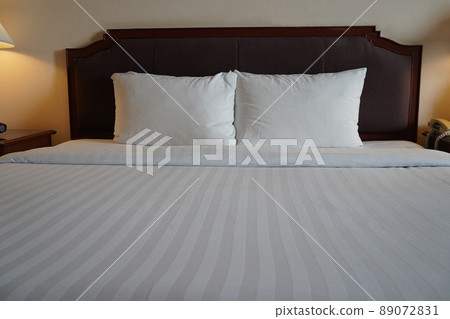 Towels and bedding on double beds in dormitories or guesthouse rooms that are empty. Towels and bedding on double beds in dormitories or guesthouse rooms that are empty. 89072831