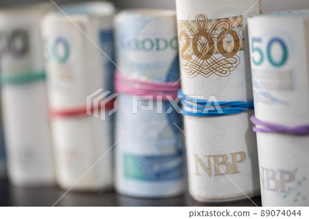 Lined up diagonally, official Polish banknotes rolled up. Lined up diagonally, official Polish banknotes rolled up. 89074044