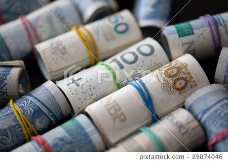 Many rolls of paper bills. Various denominations of Polish national currency. Many rolls of paper bills. Various denominations of Polish national currency. 89074046