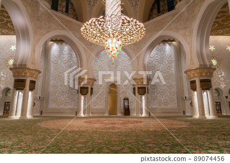 Abu Dhabi, United Arab Emirates - February 2022: Golden Chandelier inside Sheikh Zayed Grand Mosque. Grand Mosque of Abu Dhabi. Abu Dhabi, United Arab Emirates - February 2022: Golden Chandelier inside Sheikh Zayed Grand Mosque. Grand Mosque of Abu Dhabi. 89074456