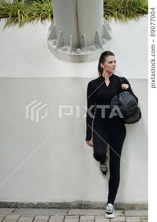 Woman in Dancewear Holding Gym Bag 89077004