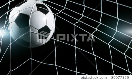 Soccer ball in goal, isolated on black background 89077539