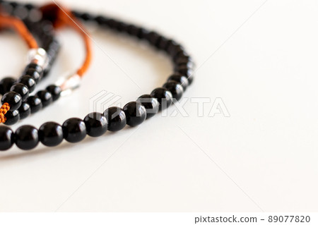 Close up on the black beads on the table Close up on the black beads on the table 89077820